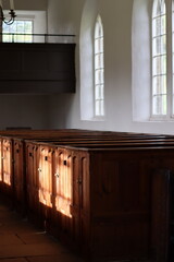 Rows of traditional wooden church pews