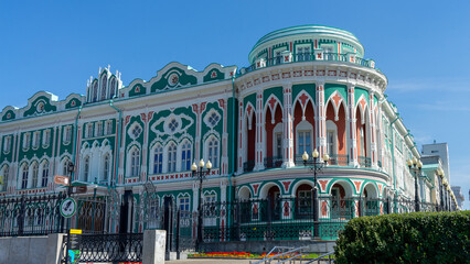 Sevastyanov's House or House of Trade Unions on shore of city pond formed by dam on Iset River....