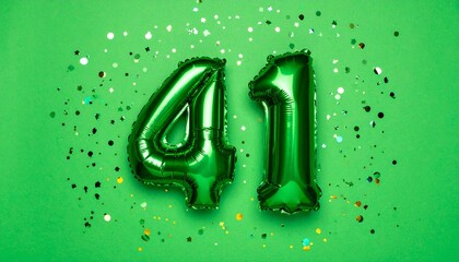 Green balloon number 41 with confetti on solid colored background. Photo for anniversary or birthday party