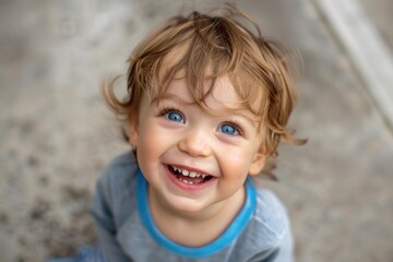 Close up of happy baby showing teeth while making eye contact, capturing innocence and joy