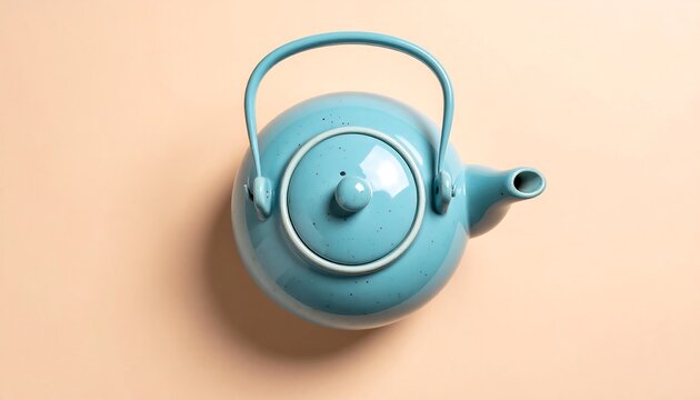 Overhead shot of a robin's egg blue ceramic teapot on a pastel surface