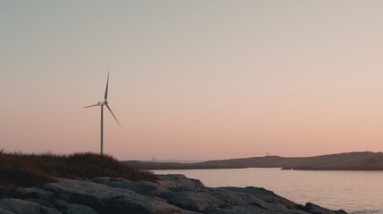 Wind turbine on a rocky shore at sunset. the sky is a beautiful shade of pink and orange, with the sun setting in the background.