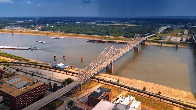 Rising over the waterfront of the Mississippi River in St. Louis, Missouri, USA. View on the Martin Luther Bridge and Eads Bridge across the river.