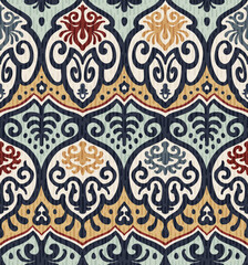 Vector seamless ikat textile pattern with ornamental ethnic motifs in white blue yellow and terracotta colors