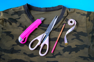 A t-shirt with scissors to cut a new neckline.Diy recycle old clothes concept.