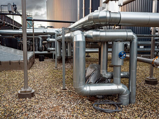Detailed view of a modern biogas installation in rural Denmark, showing tanks, pipes, and clean...