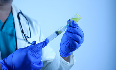 doctor's hand holds a syringe and a vaccine bottle at the hospital. Health and medical concepts. vaccination flu shot paramedics in hospital concept.selective focus hand doctor syringe injection.