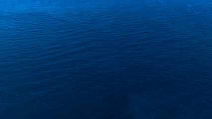 Aerial view of the blue ocean surface. The sea waters are calm. Ideal for textures, patterns, and backgrounds.