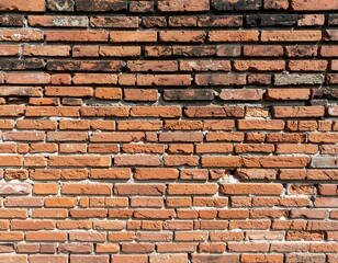 Obraz premium A close-up view reveals a textured, weathered brick wall. The arrangement of the rectangular bricks exhibits variations in tone and age