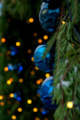 Festive pine tree decoration captured with a cozy, bokeh-filled Christmas background