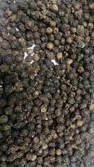 Black Pepper Seeds Close-up on White Background