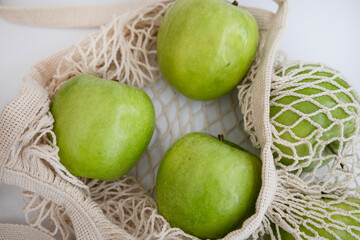 Healthy Fresh Green Apples in Eco Mesh Bag on White Background – Diet, Fitness and Organic Lifestyle Stock Photo
