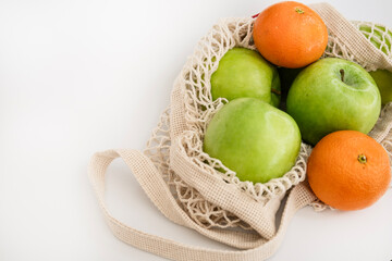 Eco Mesh Bag with Green Apples and Fresh Tangerines on White Background – Organic Fruit Flat Lay