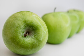 Luxury Minimalist Flat Lay of Green Apples in Diagonal Row on White Background with Copy Space