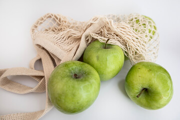 Fresh Green Apples in Eco Mesh Bag on White Background with Copy Space – Healthy Organic Food Flat Lay Stock Photo