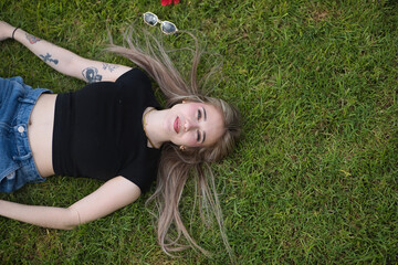 Young woman, beautiful, blonde, green eyes, relaxed and calm, seen from above, looking at the...