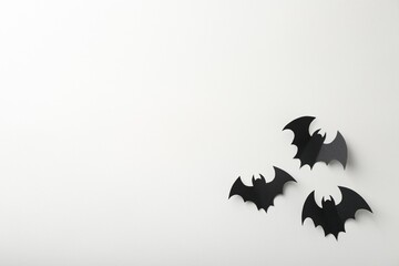 Halloween decor. Black paper bats on white background, flat lay. Space for text