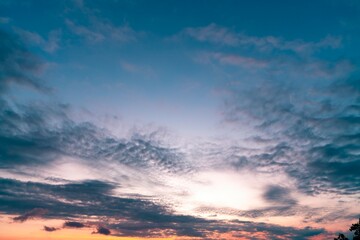 Sky with clouds on nature background above tropical beach at colorful sunset 4K