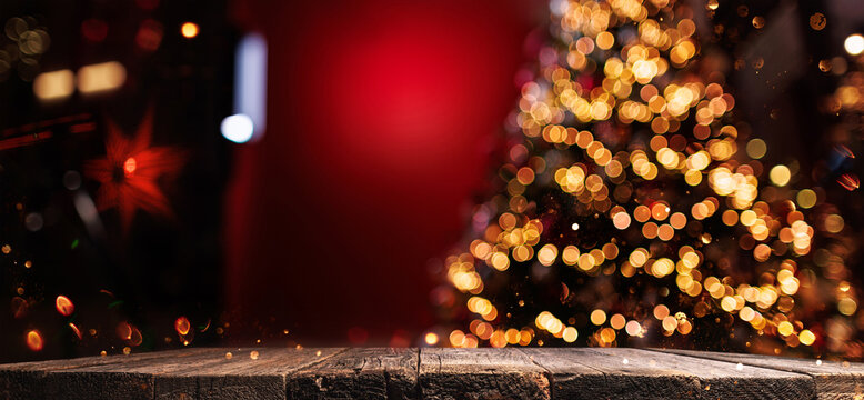 Christmas Tree with Illumination on Red Background. Old Wooden Boards