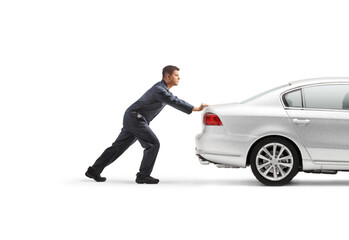 Auto mechanic pushing a car