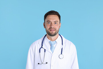 Fototapeta premium Pediatrician with stethoscope on light blue background