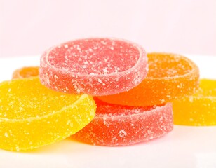 A close-up shot displays a pile of colorful, circular sweets with a sugared exterior. Different hues
