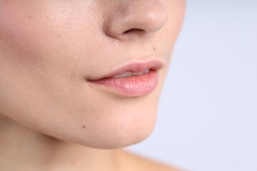 Obraz premium Woman with normal skin on light background, closeup. Space for text