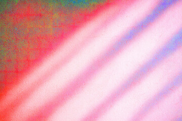 Diagonal shadows cast colorful patterns on a textured wall. Soft hues of pink, red, and blue create a vibrant and dynamic composition.AI generated.