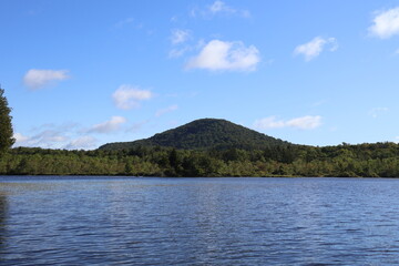 A panoramic view of a lake nestled in the Adirondacks.