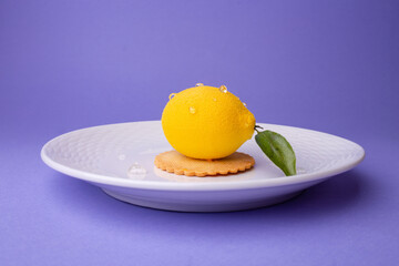 Lemon dessert on plate: side view with droplets and leaf - freshness in elegant plating