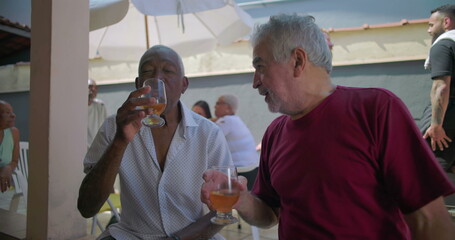 Two elderly friends sharing laughter and drinks at a backyard barbecue, enjoying camaraderie and connection during a lively and cheerful outdoor gathering