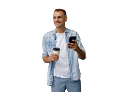 Man smiling, holding coffee and smartphone while browsing apps and texting, relaxed and confident on transparent background