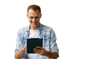 Young man smiling, using digital tablet, browsing social media, enjoying online content, having fun with technology