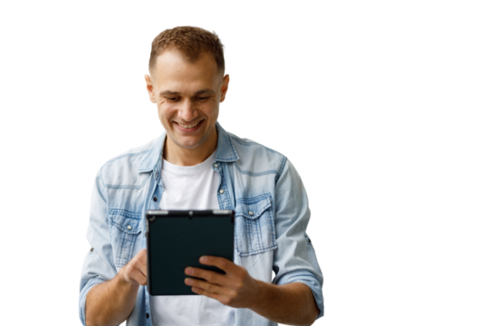 Young man smiling, using digital tablet, browsing social media, enjoying online content, having fun with technology