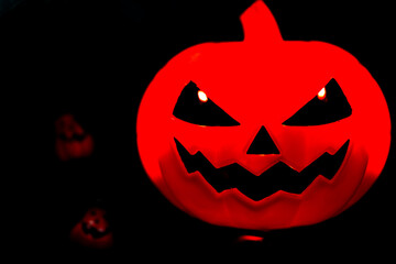 Plastic Pumpkin carved into spooky demon face for haloween