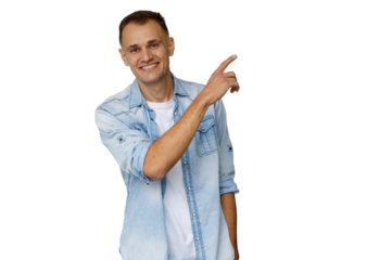 Smiling man pointing finger up, showing direction or attention, casual denim, transparent background