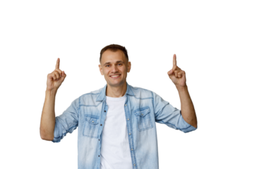 Smiling man pointing up showing advertising space, good idea or solution with positive expression on transparent background