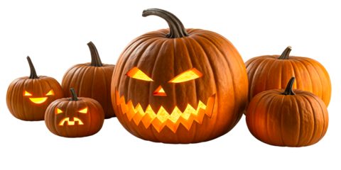 Group of carved pumpkins with glowing faces and lit candles