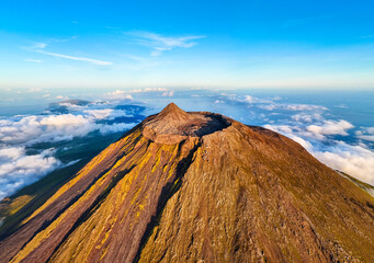 Panorama of Mount Pico Stratovolcano, Crater and Clouds at Sunset. Shadow of Mountain. Atlantic Ocean. Golden Hour. Pico Island, Azores. Portugal. Aerial View