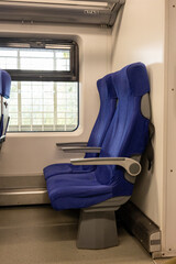Two comfortable passenger seats inside modern high-speed train.