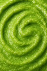 green puree swirled in a spiral pattern representing fresh vegetable puree healthy diet and vibrant food background