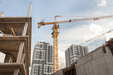 Construction site bustling with activity under a clear blue sky in an urban area