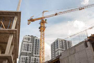 Construction site with a tall crane and modern buildings under development in a city