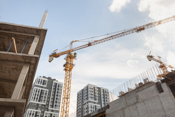 Construction site with cranes under a clear sky in a modern urban area during the day