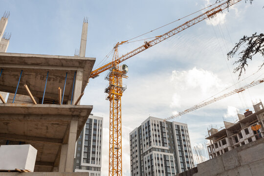 Construction site showcasing cranes and developing residential buildings in a bustling urban area