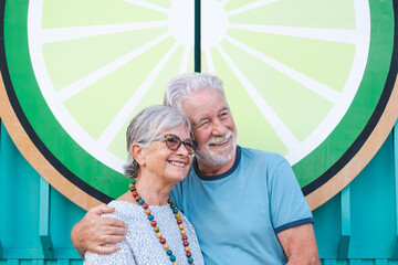 Lovely senior couple hugging smiling standing in outdoors. Youthful couple enjoying retirement