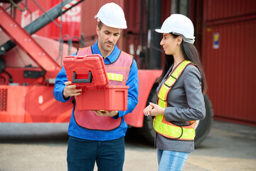 Engineers or workers giving a toolbox, embodying teamwork and cooperation at the container yard