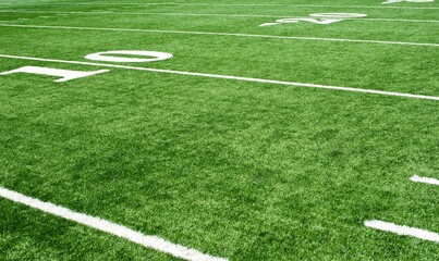 Corner of football field with green grass and white lines