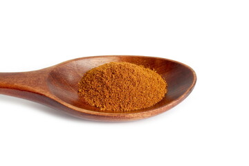 Red hot pepper powder lies on a wooden spoon on a white background.	