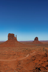 View of red sand desert region on the Arizona-Utah border known for big towering red sandstone buttes was called Monument Valley, United States.